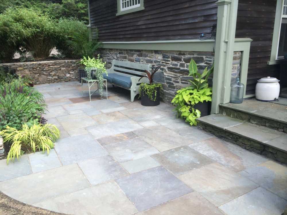 This older home demanded a more aged look.  Clumping bamboo creates privacy while various shade tolerant plants soften the edges of this outdoor retreat. 